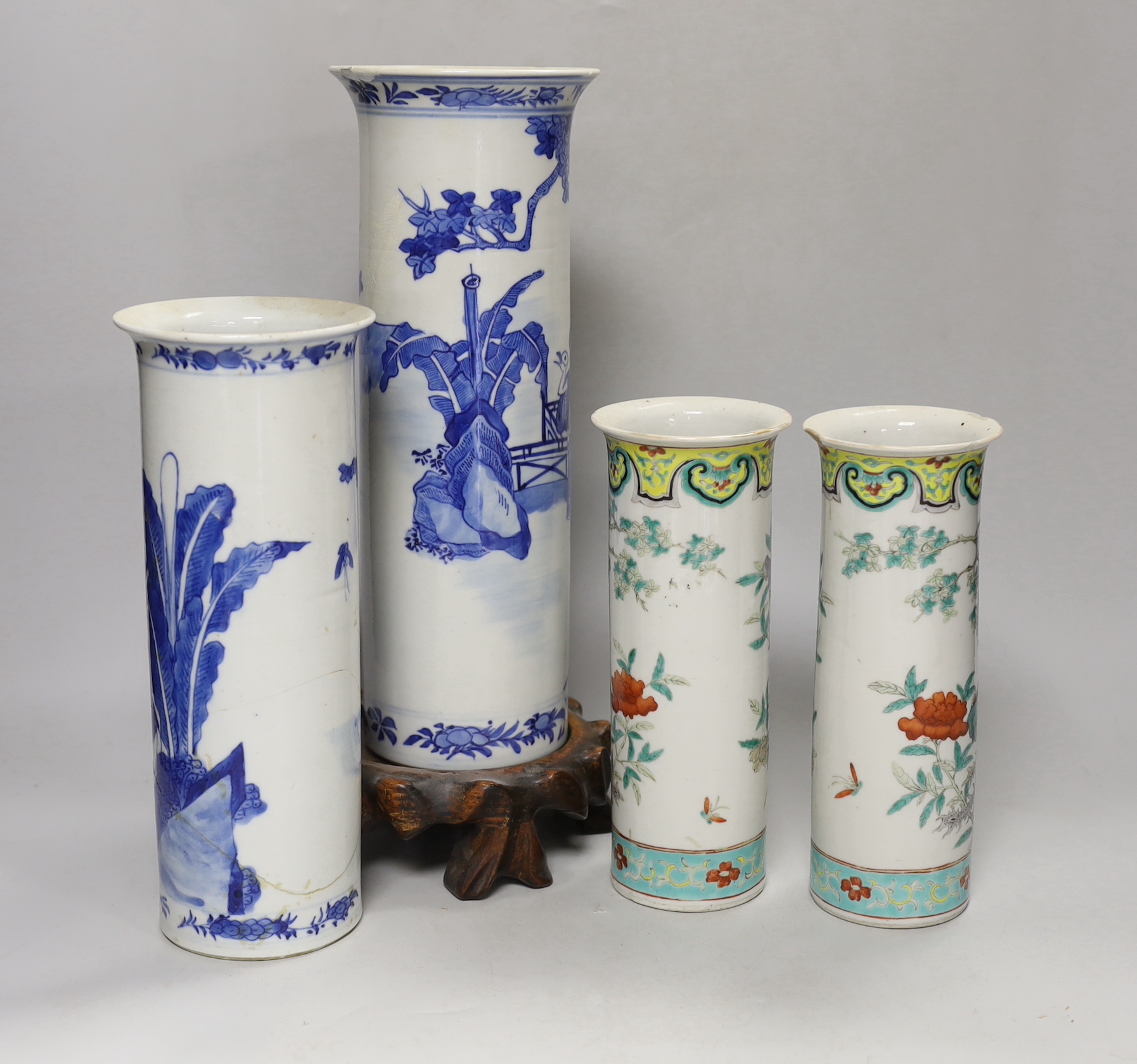 Two 19th century Chinese blue and white cylinder vases, one on stand and a pair of famille verte cylinder vases, tallest 30cm high